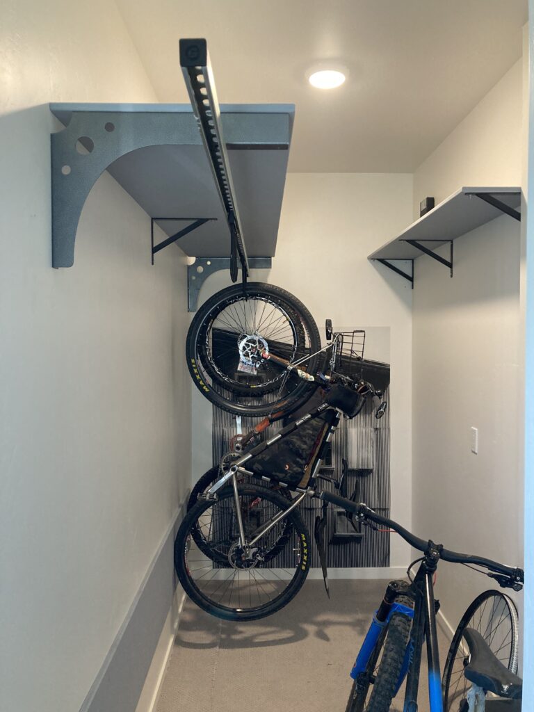 Bikes in closet after installation of the sliding bike rack in a closet.